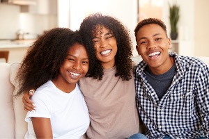 Family smiling on couch 